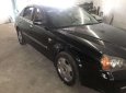 Cần bán gấp Daewoo Magnus đời 2004, màu đen, 132tr